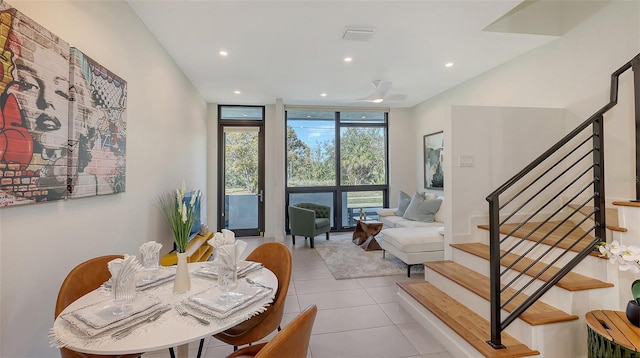 tiled dining area featuring recessed lighting, expansive windows, visible vents, and stairway