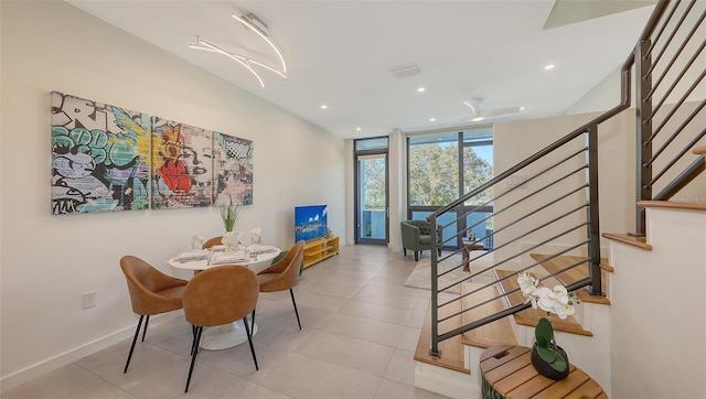 dining space featuring a wall of windows, stairway, light tile patterned floors, and recessed lighting