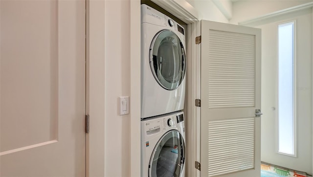 washroom featuring laundry area and stacked washer and dryer