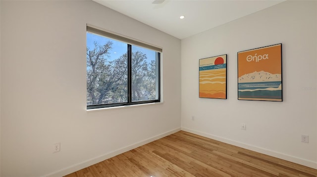 unfurnished room featuring recessed lighting, baseboards, and light wood-style flooring