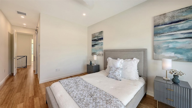 bedroom featuring visible vents, recessed lighting, baseboards, and wood finished floors