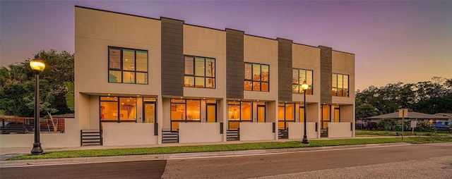 view of outdoor building at dusk