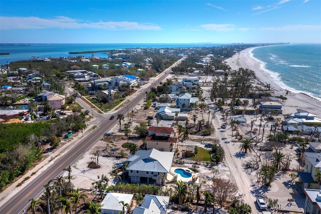 birds eye view of property featuring a water view and a view of the beach