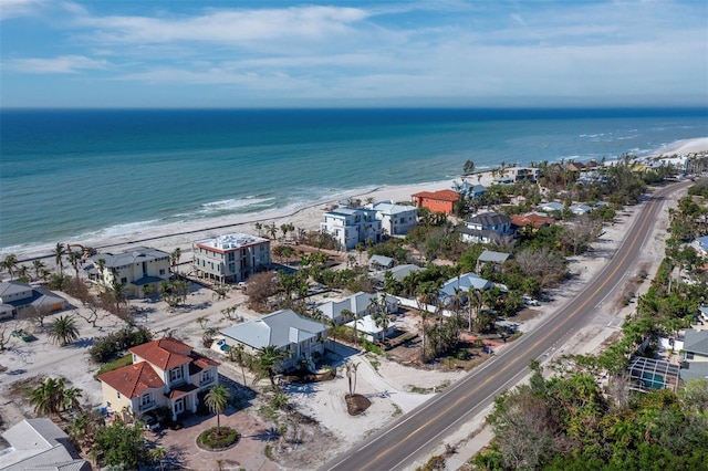 birds eye view of property featuring a beach view and a water view