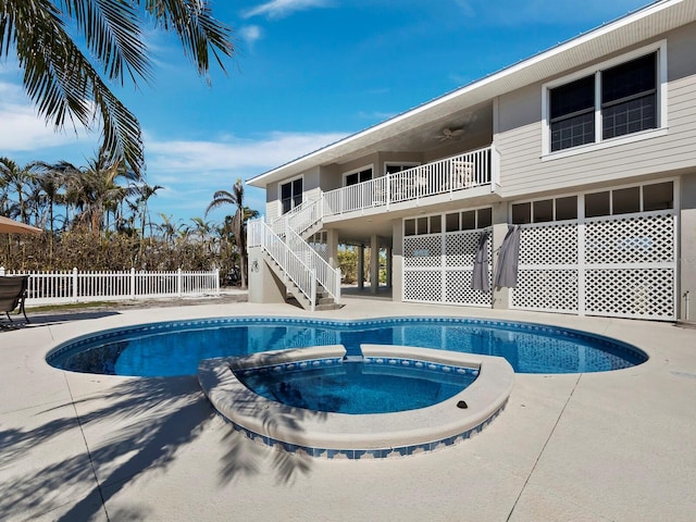 view of pool with ceiling fan and an in ground hot tub