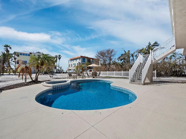 view of swimming pool featuring a patio and an in ground hot tub