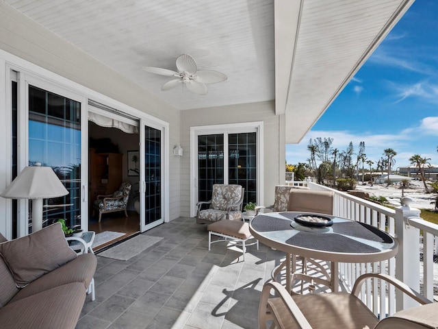 balcony with ceiling fan and a patio area