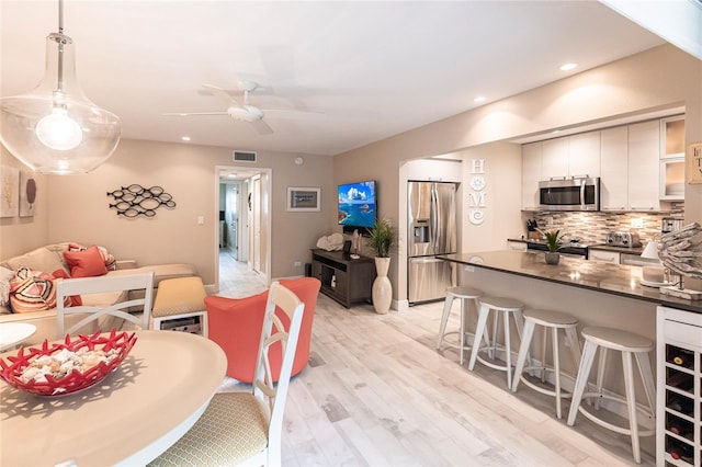 145 Avenida Messina Unit 3, Sarasota, FL 34242 - dining area featuring ceiling fan and light hardwood / wood-style flooring
