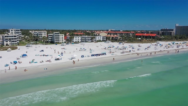 aerial view with a water view and a view of the beach