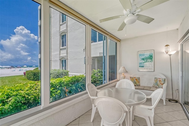 sunroom / solarium featuring ceiling fan