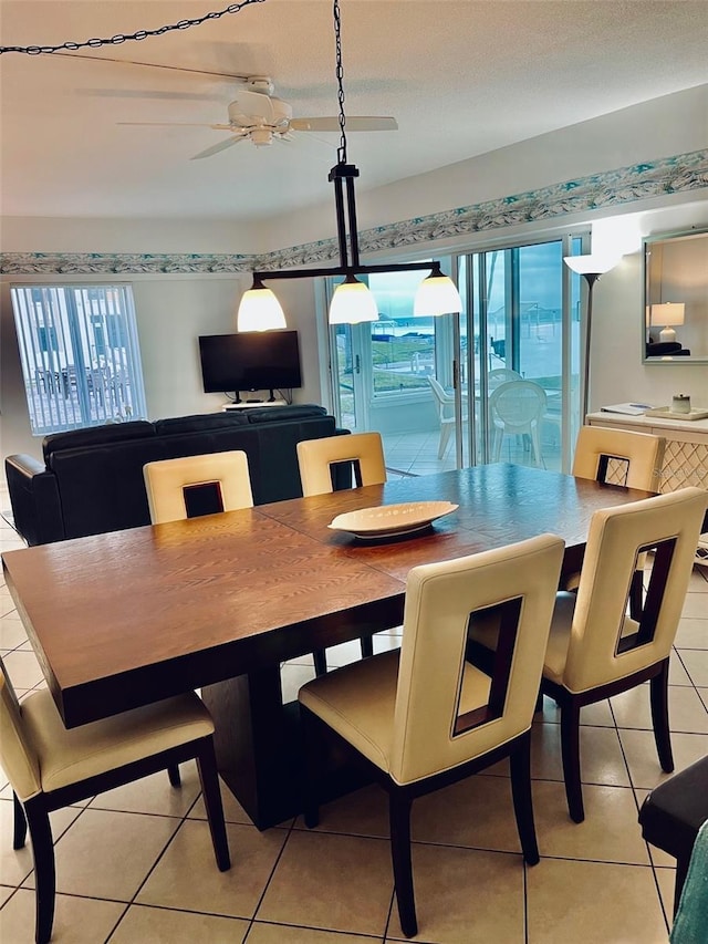 dining space with ceiling fan, light tile patterned floors, and plenty of natural light