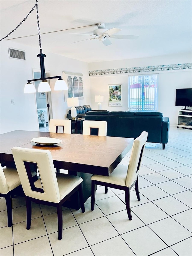 tiled dining area with ceiling fan