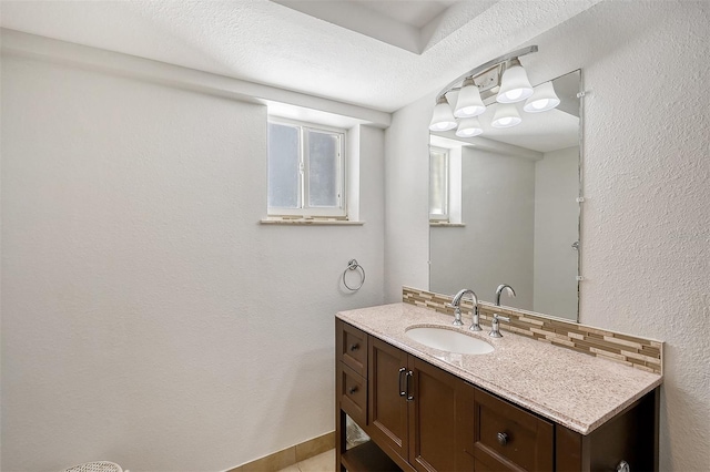 bathroom with a textured ceiling and vanity