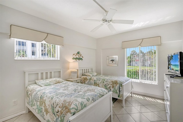 bedroom with ceiling fan and light tile patterned floors