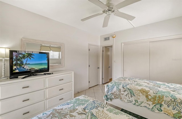 tiled bedroom with a closet and ceiling fan