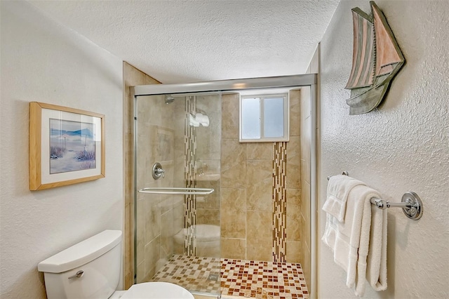 bathroom with toilet, a textured ceiling, and a shower with shower door