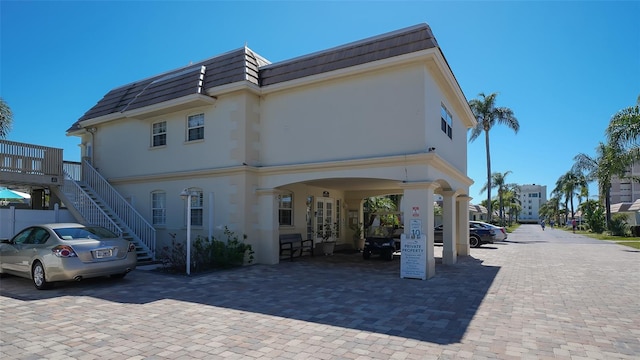 back of house featuring a carport