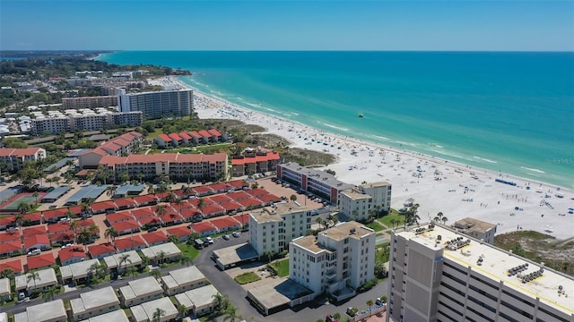 birds eye view of property featuring a beach view and a water view