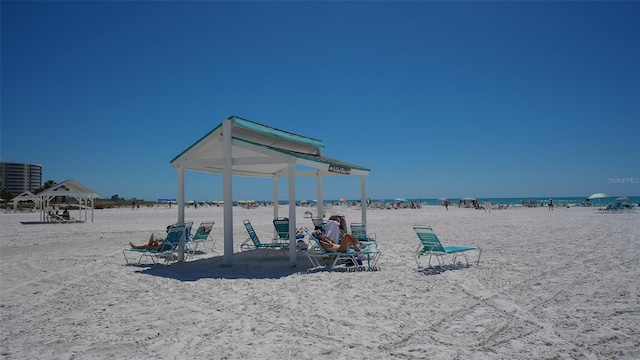 exterior space featuring a beach view and a water view