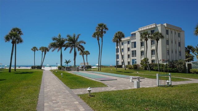 view of community featuring a yard and a water view