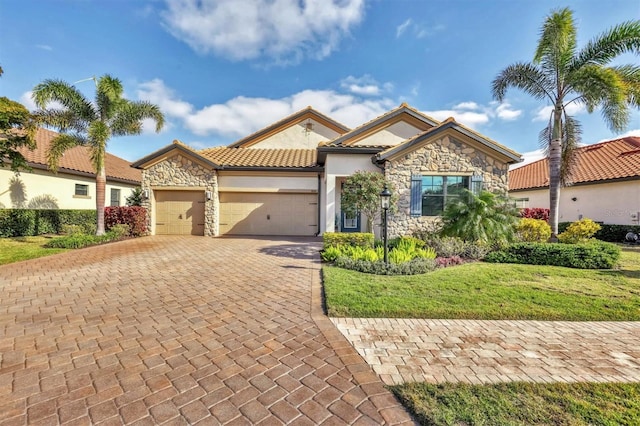 mediterranean / spanish-style house featuring a front lawn and a garage