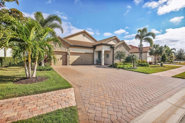 mediterranean / spanish-style home featuring a front yard and a garage