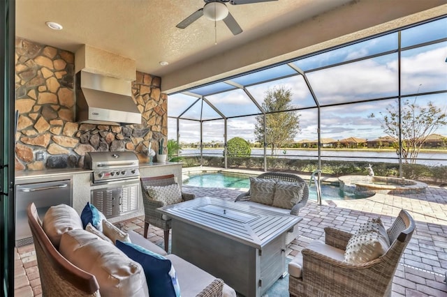 view of patio with an outdoor hangout area, a water view, grilling area, a pool with hot tub, and exterior kitchen