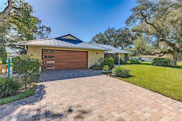 view of front of property with a front yard and a garage