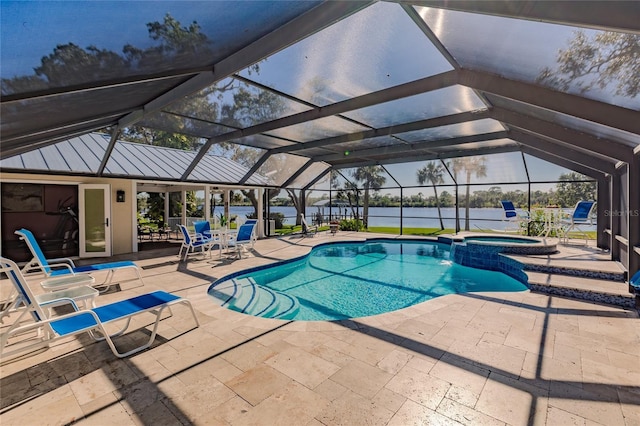 view of pool with a lanai, a water view, an in ground hot tub, and a patio