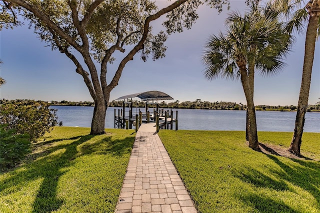 dock area featuring a lawn and a water view