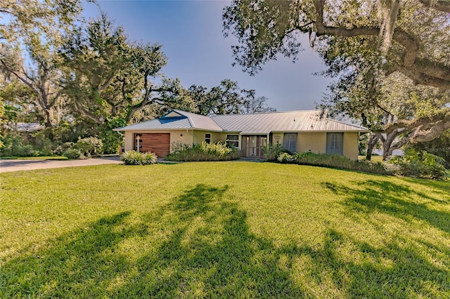 ranch-style home with a front yard and a garage