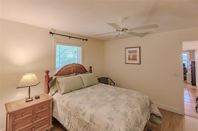 bedroom with ceiling fan and hardwood / wood-style floors