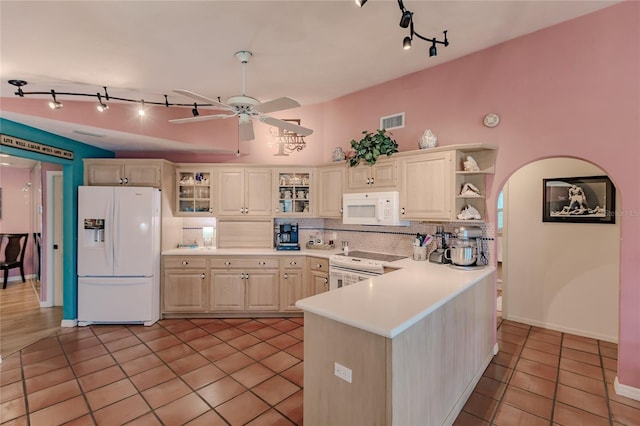 kitchen featuring light tile patterned floors, ceiling fan, tasteful backsplash, white appliances, and lofted ceiling