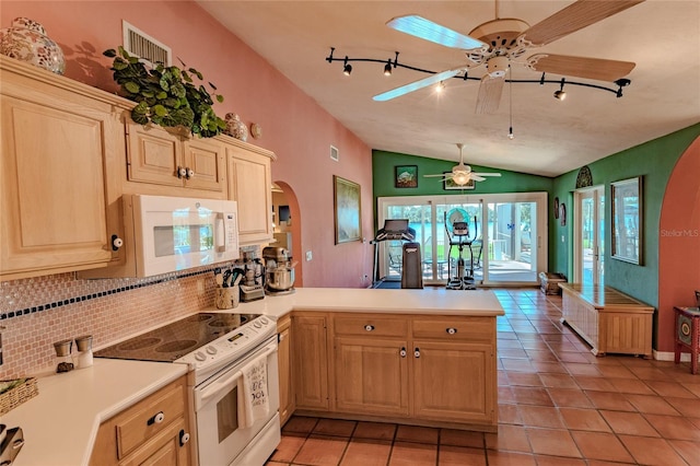 kitchen with kitchen peninsula, ceiling fan, tasteful backsplash, white appliances, and vaulted ceiling