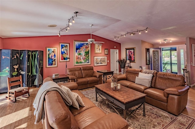 living room with lofted ceiling, ceiling fan, and light hardwood / wood-style floors