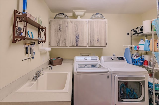 laundry room with washer and dryer, sink, and cabinets