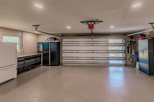 garage featuring white fridge and a garage door opener