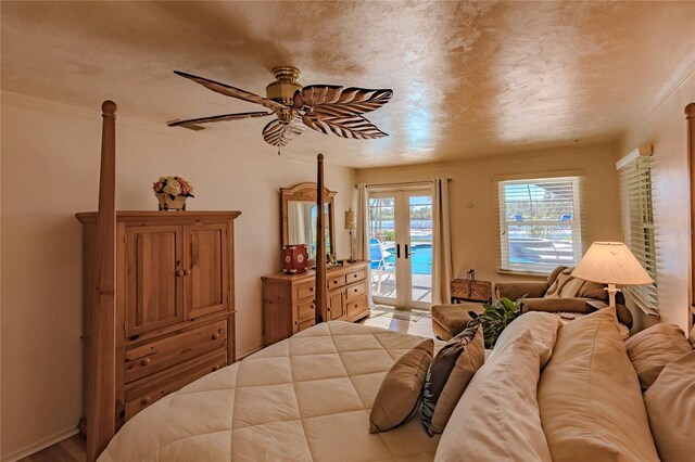 bedroom featuring ceiling fan, access to exterior, crown molding, and french doors