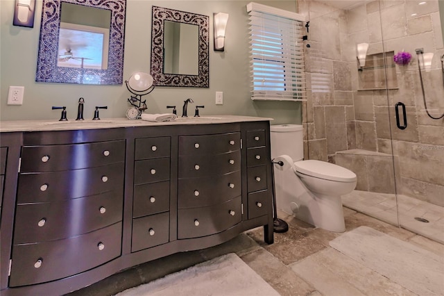 bathroom featuring vanity, toilet, and an enclosed shower