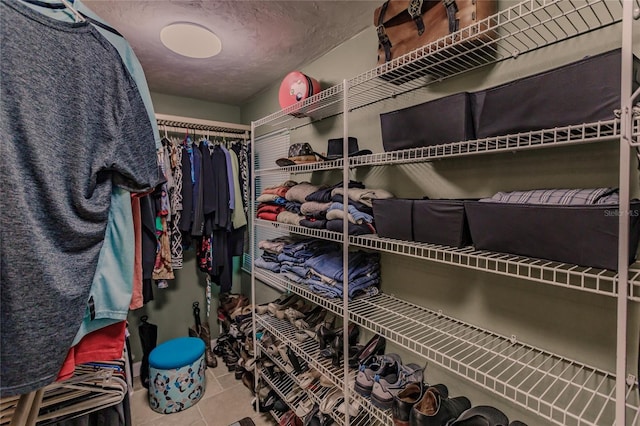 walk in closet with tile patterned flooring