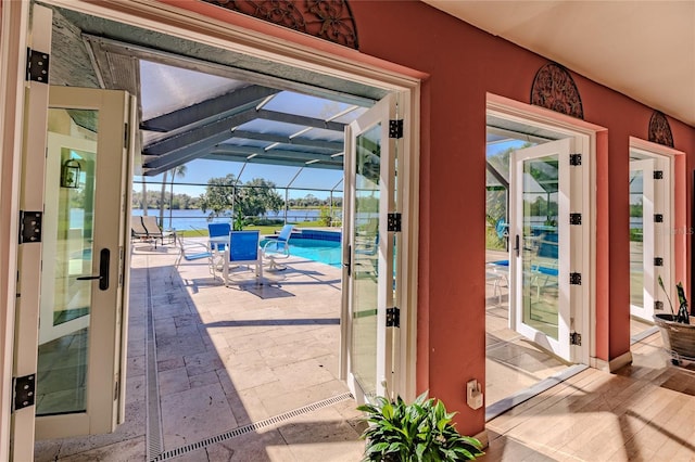 entryway featuring a water view and french doors