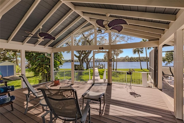 deck featuring ceiling fan, a gazebo, a yard, and a water view