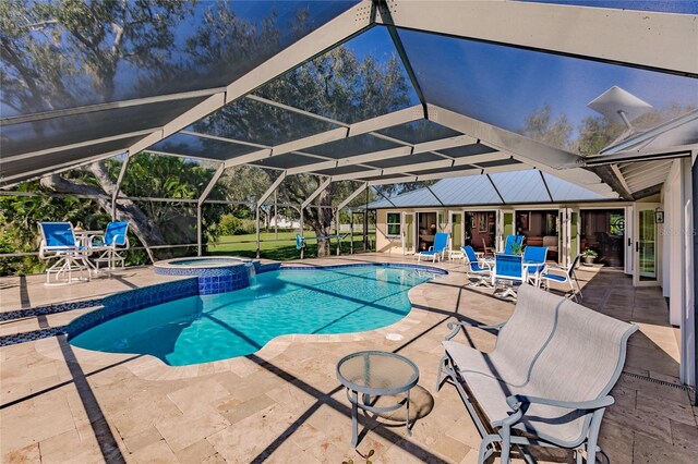 view of pool featuring a lanai, an in ground hot tub, and a patio