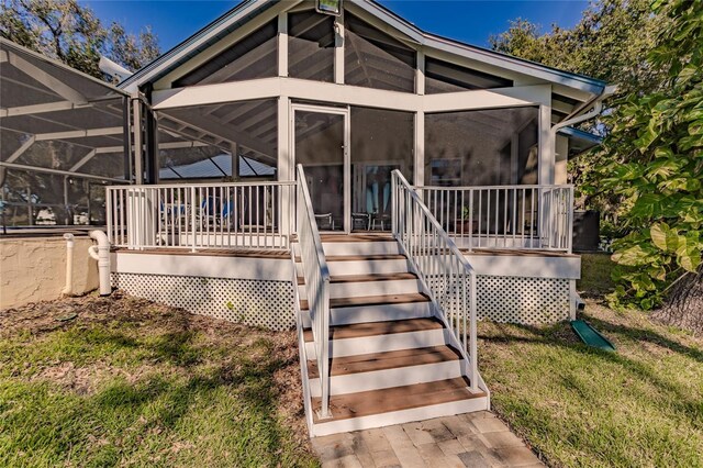 view of exterior entry featuring a yard