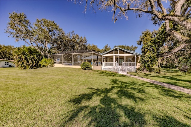 exterior space with a lanai, a sunroom, and a front yard