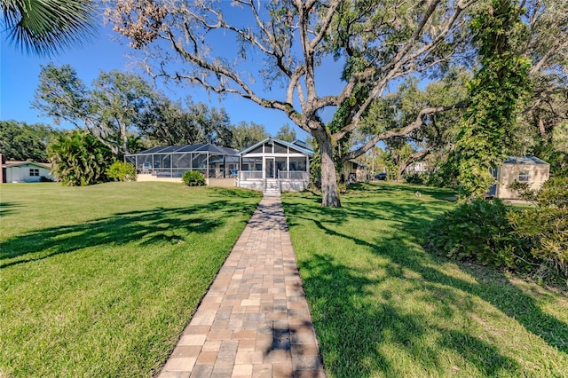 view of front facade featuring glass enclosure and a front yard