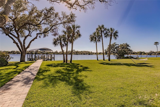 surrounding community with a yard and a water view