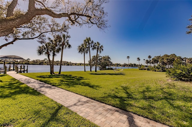 surrounding community featuring a water view and a yard