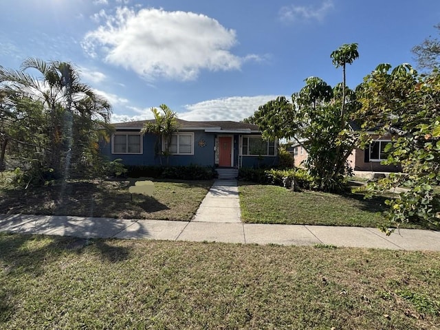 single story home with a front lawn