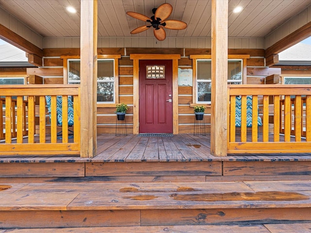 property entrance with ceiling fan and a porch